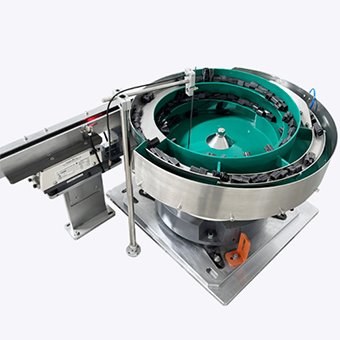 Green-lined bowl feeder with an attached outfeed track.
