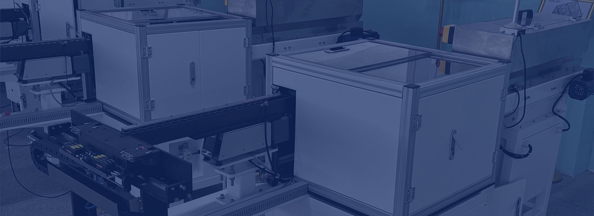 Enclosed feeding equipment with linear tracks and control panels.